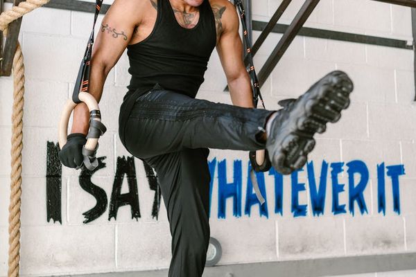Man focusing before a workout session, athletic gear nearby.