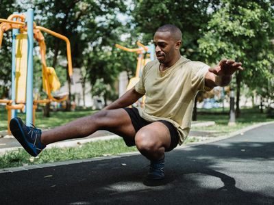 Man performing a single-leg balance exercise.
